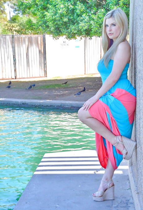 Glamorous blond cutie Danielle Delaunay exhibiting big titties and playing with dildo outside